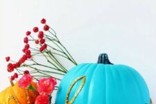 63 a bold blue pumpkin decorated with gold sequins that form a word is a cool and bright idea for Halloween
