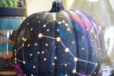 64 a galaxy pumpkin is a trendy idea for those of your who enjoy celestial Halloween decor and want something special