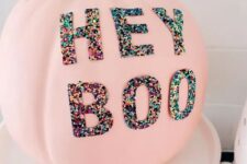 65 a pink Halloween pumpkin decorated with colorful sequin letters is a lovely and fun idea for the party