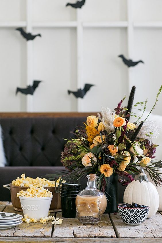 a bold Halloween flower arrangement of yellow, burgundy and blush flowers, some dried touches and foliage