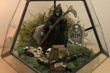 a cemeterrium or a Halloween terrarium with moss, skulls, tombstones, a death and greenery is fun and cool
