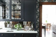 a moody kitchen with a floral wallpaper