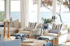a coastal living room with gorgeous views, stripes, blues and much wood in decor