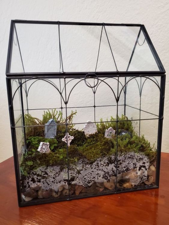a large Halloween terrarium with pebbles, moss and a graveyard is a cool solution, it won't take long to make