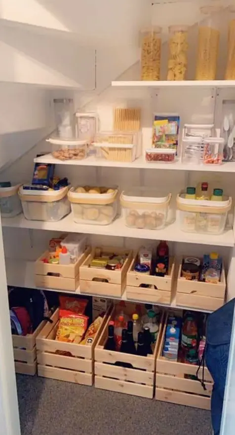 a pantry under the stairs with open shelves and cubbies, with lights and clear containers is a cool idea
