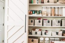a rustic pantry with barn doors, baskets, cubbies and containers and jars is a cool idea for a rustic kitchen