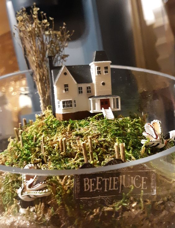 a simple Halloween terrarium with moss, a house and some snakes from Beetlejuice is a cool idea