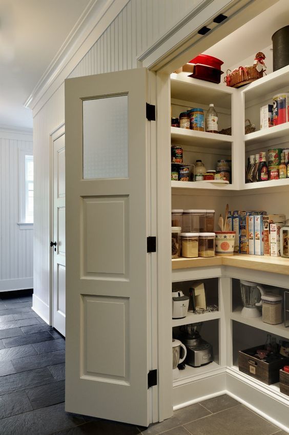 a small and cool pantry with built-in storage units and shelves, cookware, appliances, food and drinks and lots of light
