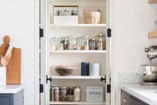 a small and cool pantry with some shelves, a stool and baskets is a cool solution to get more storage space