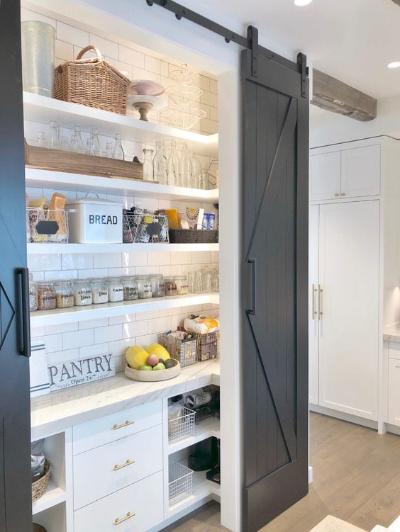 a small and cozy rustic pantry with open shelves and built-in storage cabinets, built-in lights, baskets, jars and wire baskets