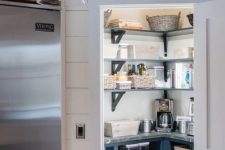 a small and stylish pantry with open shelves and built-in cabinets, baskets and jars, some lights is a cool idea
