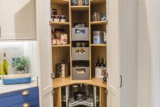a small corner pantry with open shelves, drawers, built-in lights, cookware and food, some wine bottles