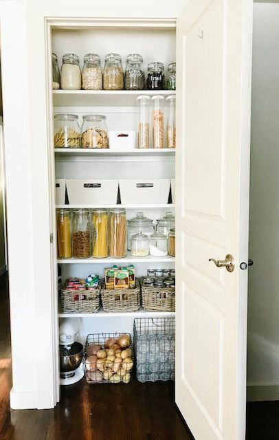 a small kitchen pantry with shelves and wire baskets plus cubbies is a cool idea to enlarge your storage space