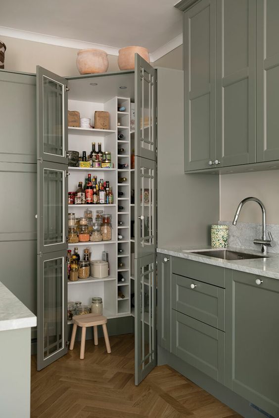 A small pantry perfectly blending with the kitchen, with built in shelves and wine storage plus a small stool is a smart idea