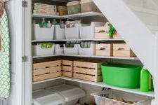 a small pantry under the stairs, with built-in shelves, cubbies, containers and boxes is a cool idea for a modern home