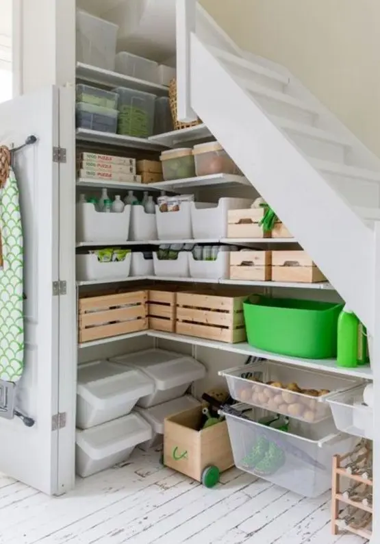 a small pantry under the stairs, with built-in shelves, cubbies, containers and boxes is a cool idea for a modern home