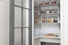 a small pantry with open shelves, built-in storage units, baskets, various food and cookware is a cool solution