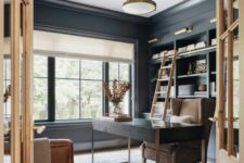 a soot modern farmhouse home office with soot walls and matching cabinets, a dark-stained desk, a beige chair and brown leather ones