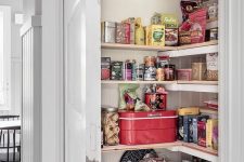 a tiny pantry with corner shelves, cookware and door is a smart solution to keep your space decluttered