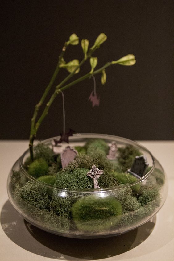 a very easy to make Halloween terrarium with moss, tombstones and a tree is a cool idea, repeat it easily