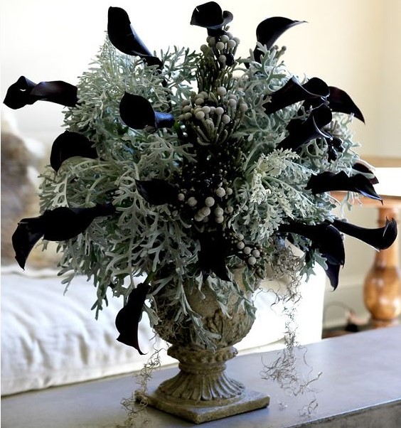 a vintage urn with pale greenery, berries and black calla lilies is a stunning and bold Halloween centerpiece
