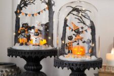 black vintage cloches with black cats dressed up, an orange pumpkin, black trees and black and orange banners