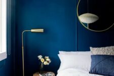 bold blue walls make a statement and look very chic with gilded touches