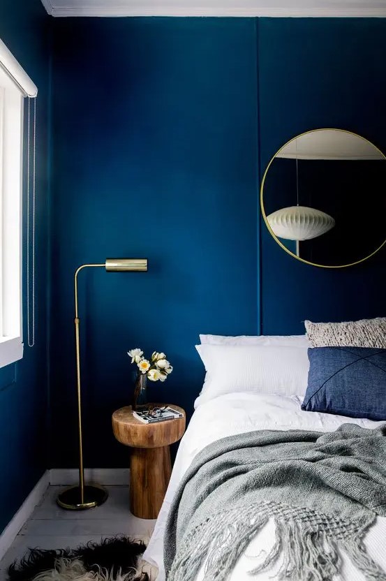 bold blue walls make a statement and look very chic with gilded touches