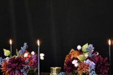 colorful Halloween arrangements of burgundy, blue, orange and purple blooms and greenery as centerpieces