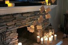 Harry Potter themed party decor with floating letters with lights and pillar candles on the fireplace is a super cool idea