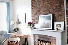 a beautiful neutral living room done in neutrals, with a red brick fireplace, a white mantel and cool and chic furniture