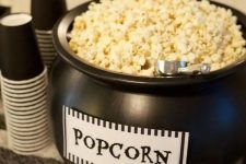 a black cauldron with popcorn is a cool way to serve this treat and it’s very Halloween-inspired and cool