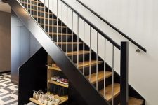 a black staircase with storage compartments and retracting shelves is a cool solution for any home, it looks cool and stylish