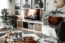 a cozy living room with a b&w gallery wall