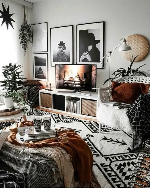 a bold boho living room with printed textiles, touches of wicker and jute and a stylish black and white gallery wall