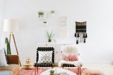a bright boho living room with an amber leather sofa, bright pillows, a coffee table, a leather pouf and macrame on the wall
