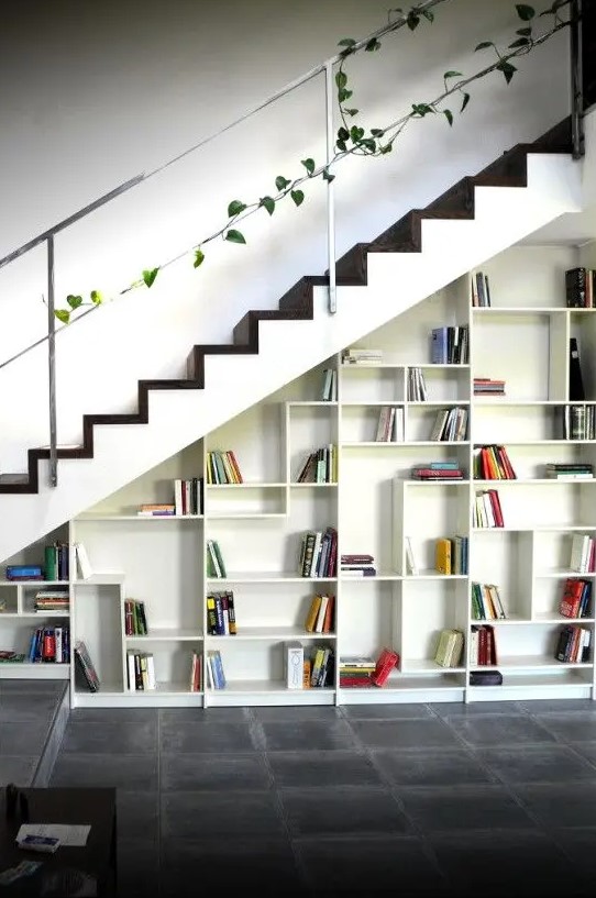 A built in bookcase with geometrically placed shelves and books becomes a cool decor feature