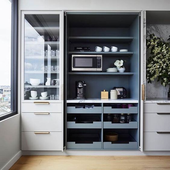 a built-in open pantry with open shelving, drawers, appliances, tableware and other stuff is a comfy unit