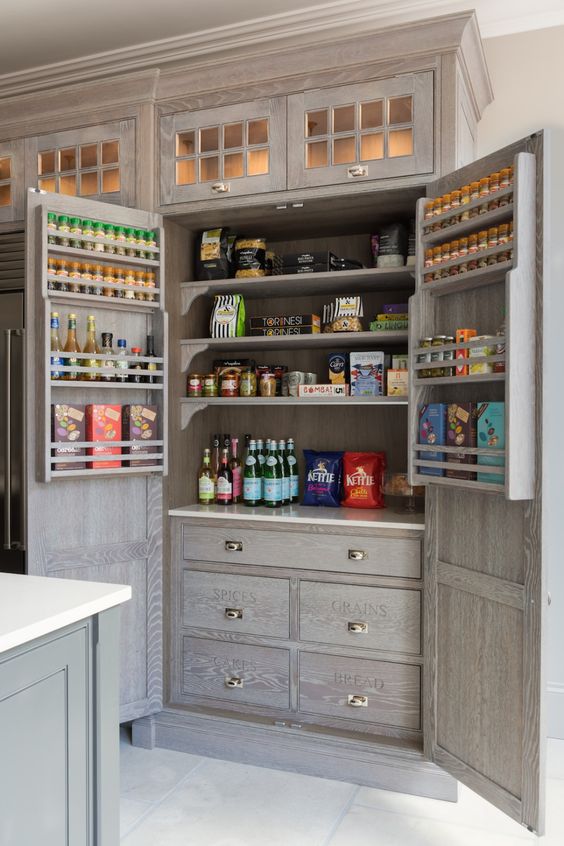 a built-in pantry that pefectly matches the cabinetry, with drawers, shelves and shelves on the doors is a smart idea for a kitchen