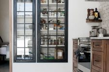 a built-in pantry with framed glass doors that keep it in order but allow you see what’s inside