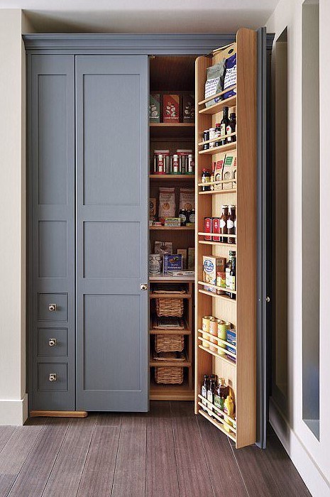 A built in pantry with lots of basket drawers, shelves on the doors and inside is a cool idea to use an awkward nook