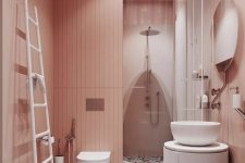 a catchy rose bathroom with pink walls, a colroful terrazzo floor, a roudn vanity and a round sink and a ladder