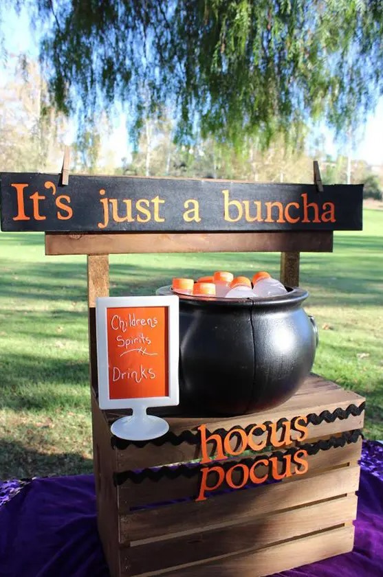 a cauldron filled with drink bottles is a cool idea for a kids' Halloween party, it can be also used to serve sweets