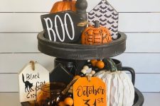 a classic Halloween stand with bright beads, orange pumpkins, candle lanterns and wooden signs with Hallowene prints