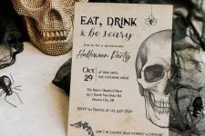a classic graphic Halloween invitation with spiders, bats and a skull will never go out of style