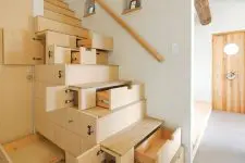 a creative and smart stained staircase with drawers built-in to store and hide some stuff is a perfect solution for a modern home