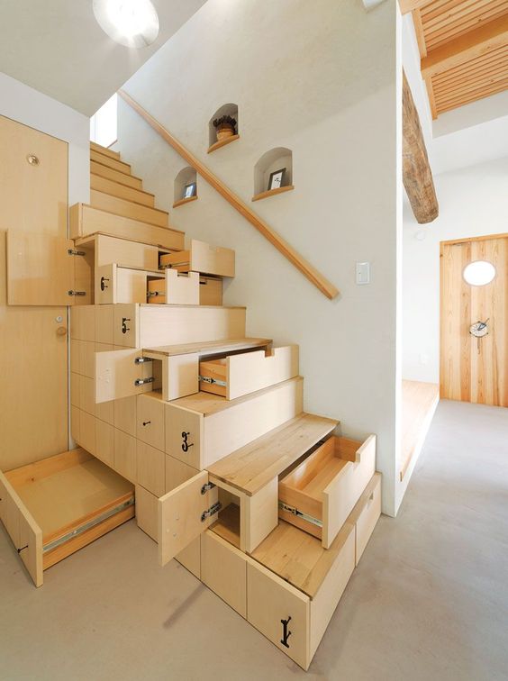 a creative and smart stained staircase with drawers built-in to store and hide some stuff is a perfect solution for a modern home