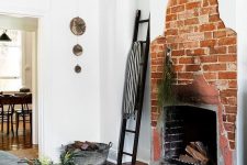 a creative asymmetrical red brick fireplace is a unique feature to go for, it’s a bold solution that looks rough and unusual