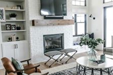 a farmhouse living room with a white brick clad fireplace – bricks accent the fireplace a lot