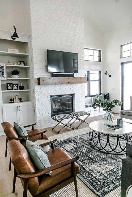 a farmhouse living room with a white brick clad fireplace - bricks accent the fireplace a lot